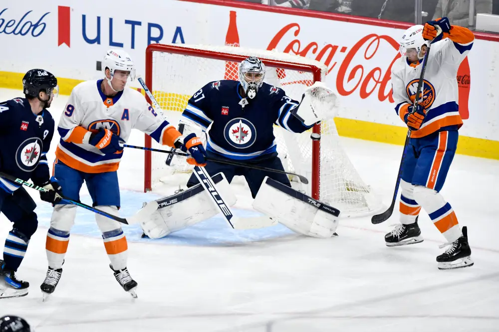 Connor Hellebuyck and Brock Nelson