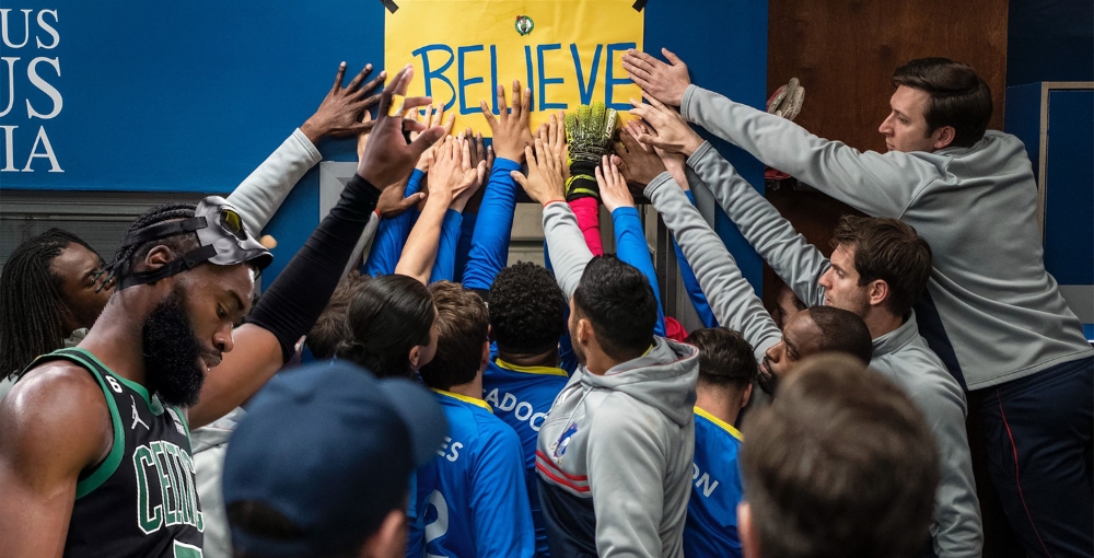 Jaylen Brown with a yellow BELIEVE sign from Ted Lasso show.