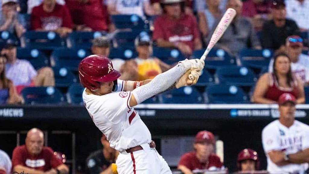 An Arkansas baseball player swings during the 2025 College World Series (Arkansas vs. Murray State CWS 6/16/2025 Prediction & Picks cover)