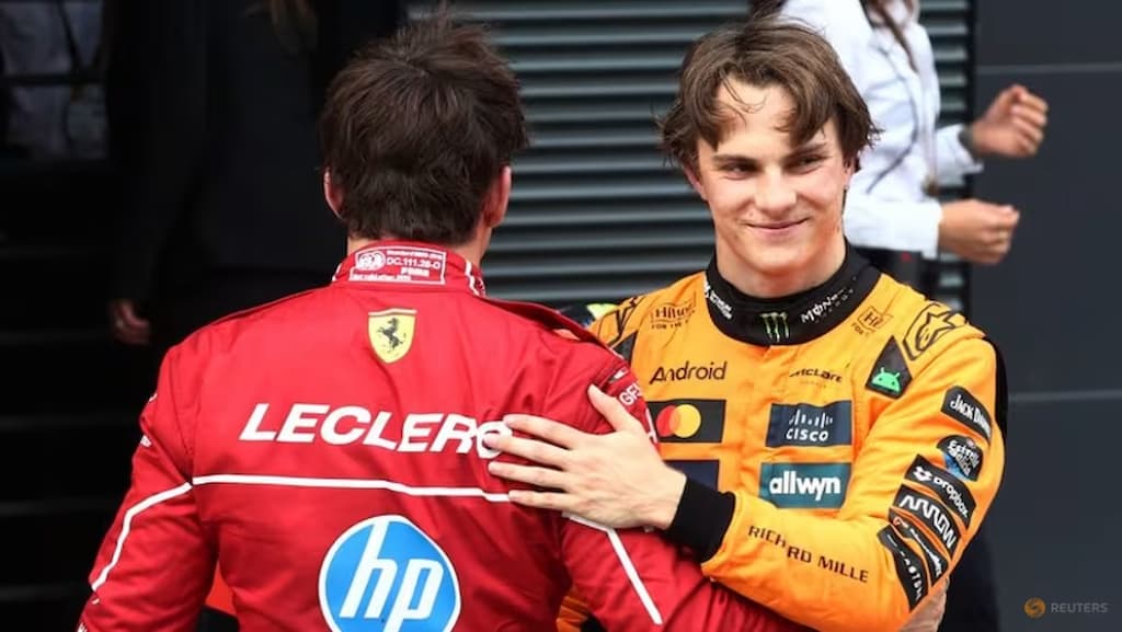Formula 1 drivers Charles Leclerc (left, with his back turned) and Oscar Piastri (right, smiling) - Formula 1 Predictions & Picks for the 2025 Hungarian Grand Prix